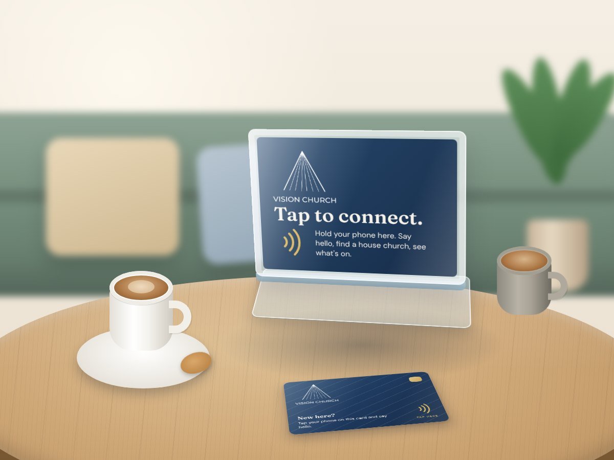 A Tap Stand on a coffee table in the café, next to a latte and a Tap Card